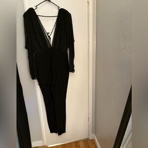 NWT Black sheer top plunging neck and back long sleeve jumpsuit.